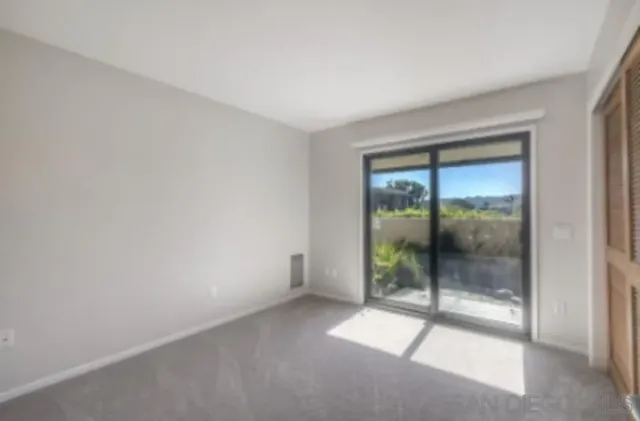 an empty room with sliding glass door