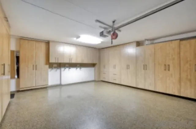 a backyard of a house with garage and outdoor seating