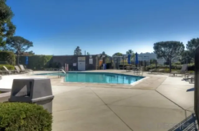 a view of a swimming pool with a yard