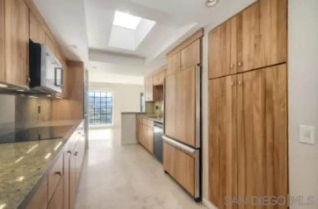 a view of a kitchen with a refrigerator