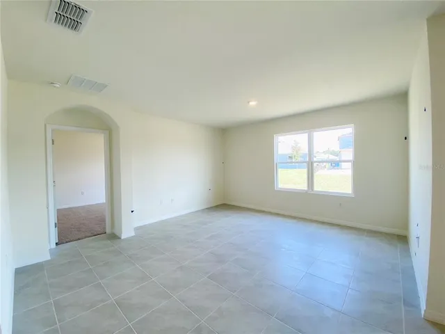 an empty room with a empty space and windows