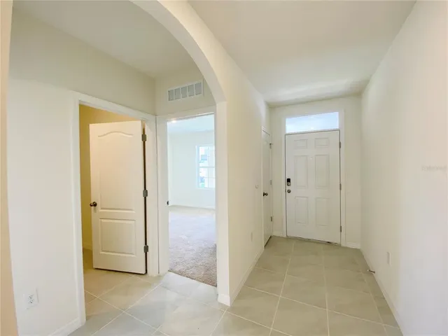 an empty room with a bench and closet