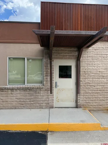 a view of a balcony with a floor to ceiling window and an oven