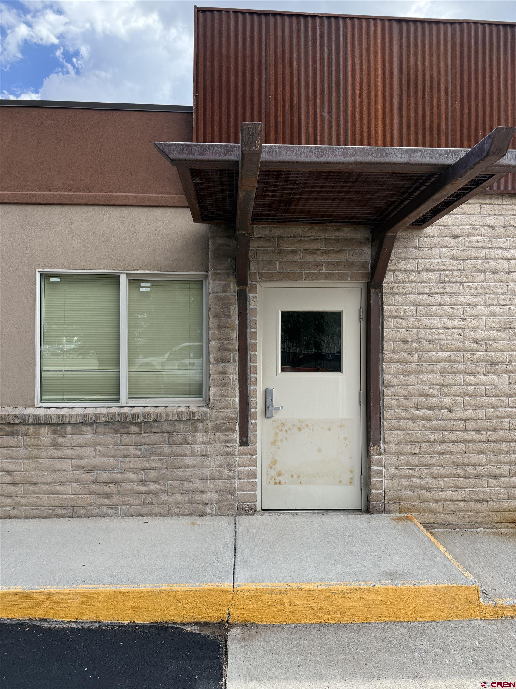 675 Industrial Boulevard, Unit 102 AND WAREHOUSE Delta, CO 81416 - Photo 2 of 24 a view of a balcony with a floor to ceiling window and an oven