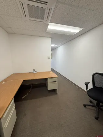 a bedroom with a bed and a desk