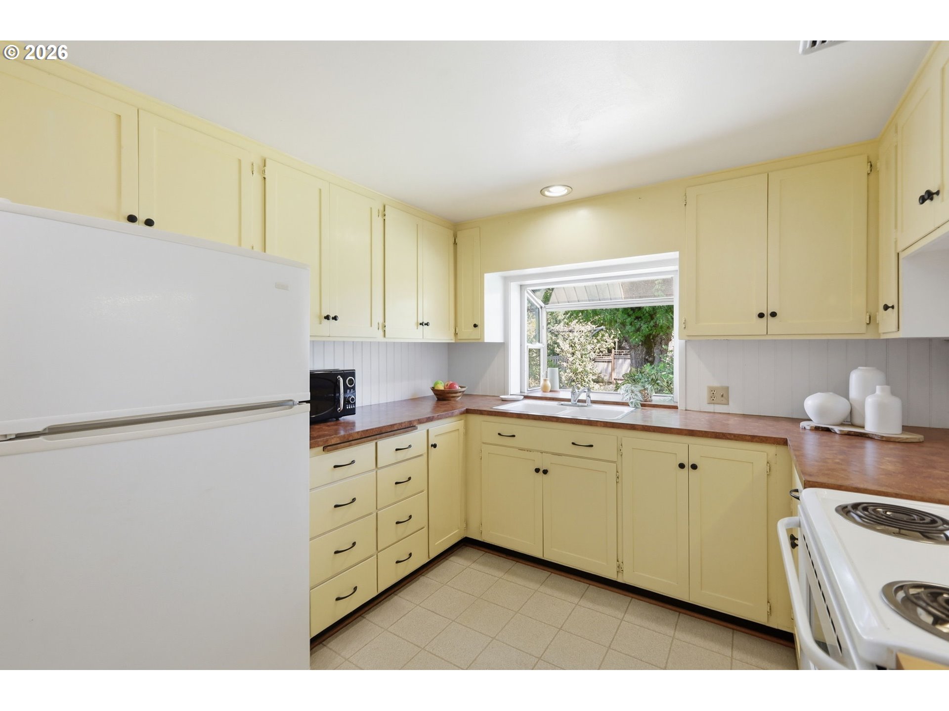 3025 Harris Street Eugene, OR 97405 - Photo 16 of 44 a kitchen with granite countertop cabinets appliances a sink and a window