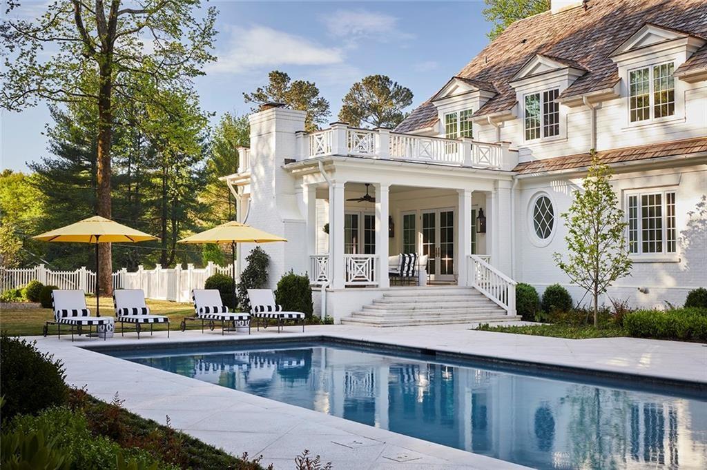 2681 Conns Creek Road Ball Ground, GA 30107 - Photo 18 of 26 a view of a white building with a swimming pool and furniture