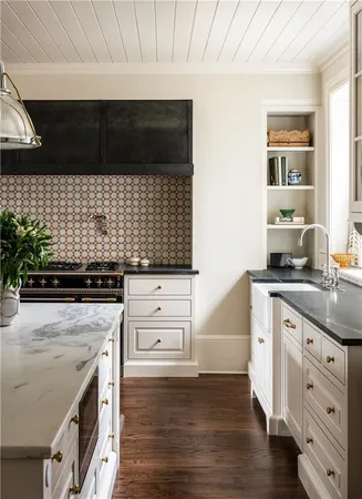 a stove top oven sitting inside of a kitchen