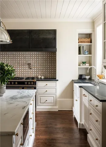 a stove top oven sitting inside of a kitchen