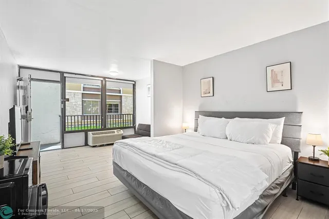 a spacious bedroom with a bed and a large window