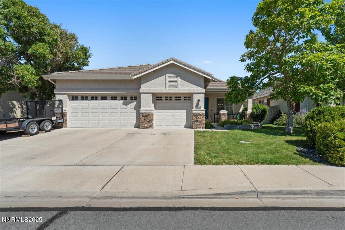 2415 Lincoln Meadows Drive Reno, NV 89521 - Photo 1 of 38 a front view of a house with a yard and garage