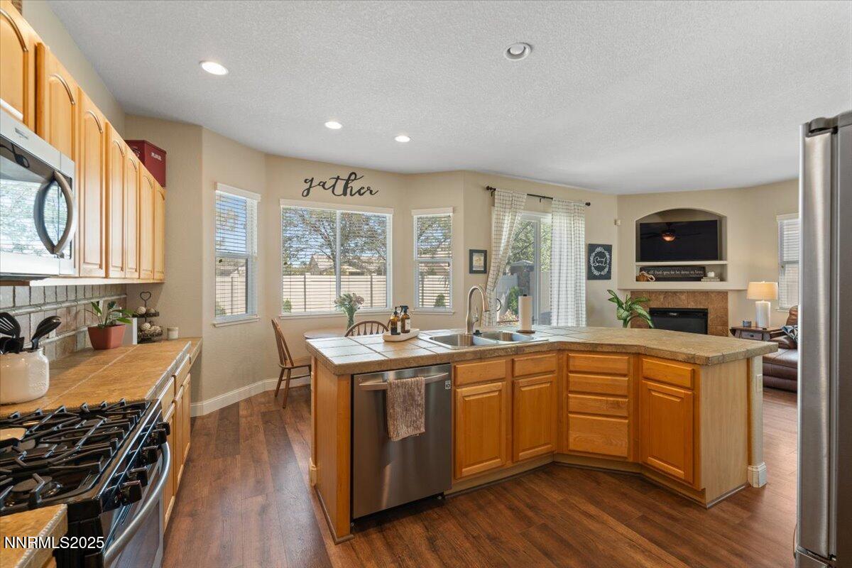 2415 Lincoln Meadows Drive Reno, NV 89521 - Photo 15 of 38 a large kitchen with stainless steel appliances granite countertop a stove and a sink