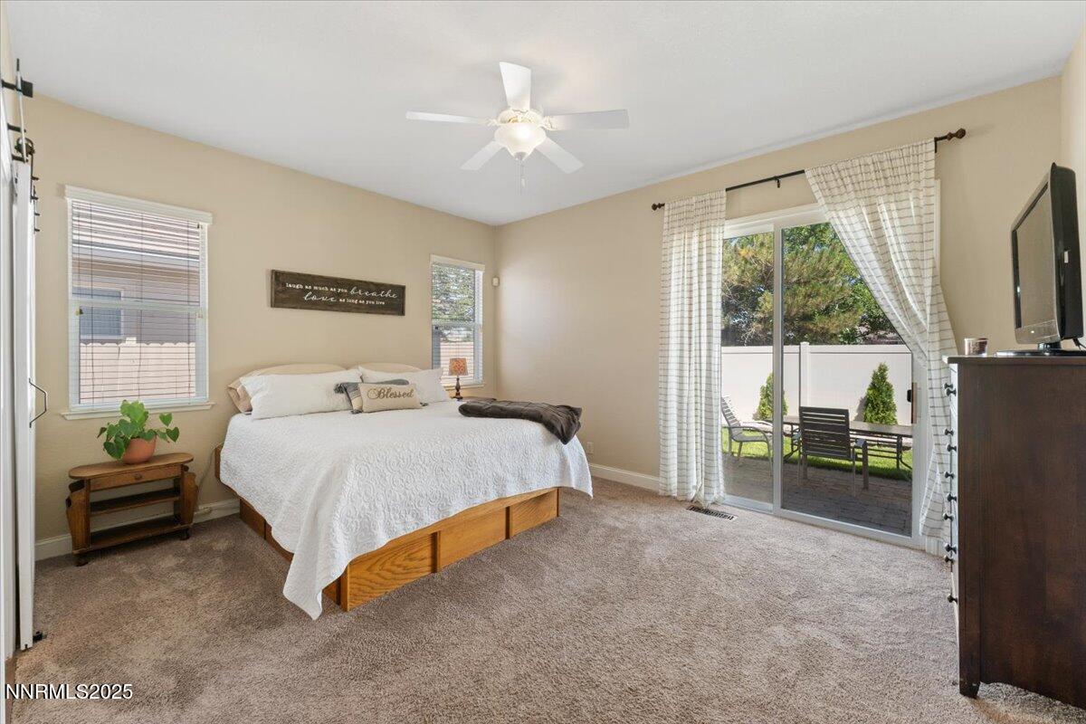 2415 Lincoln Meadows Drive Reno, NV 89521 - Photo 17 of 38 a spacious bedroom with a bed and a chandelier