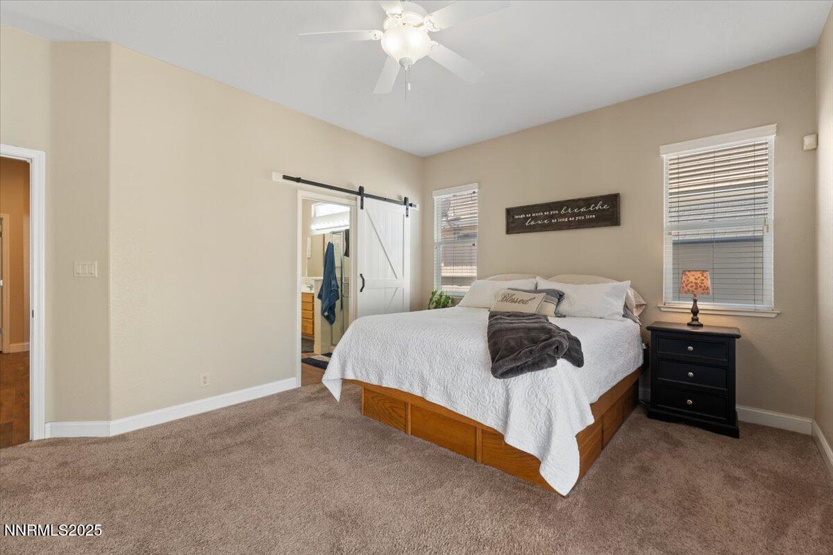 2415 Lincoln Meadows Drive Reno, NV 89521 - Photo 18 of 38 a bedroom with a bed and a chandelier