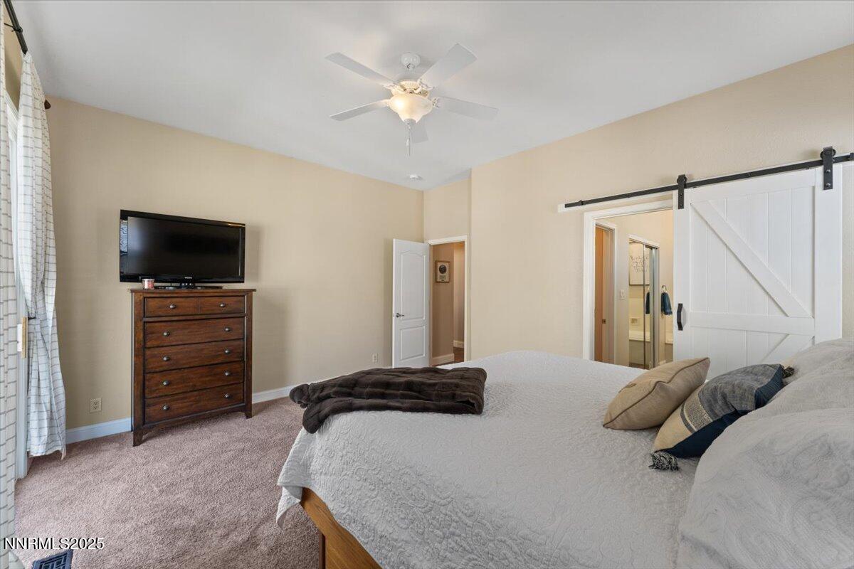 2415 Lincoln Meadows Drive Reno, NV 89521 - Photo 19 of 38 a bedroom with a bed and a television