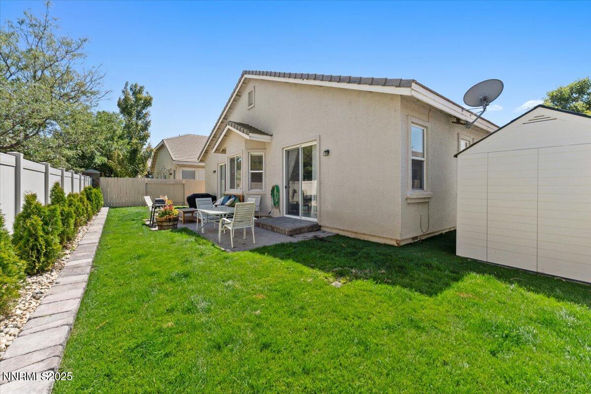 2415 Lincoln Meadows Drive Reno, NV 89521 - Photo 35 of 38 a backyard of a house with table and chairs