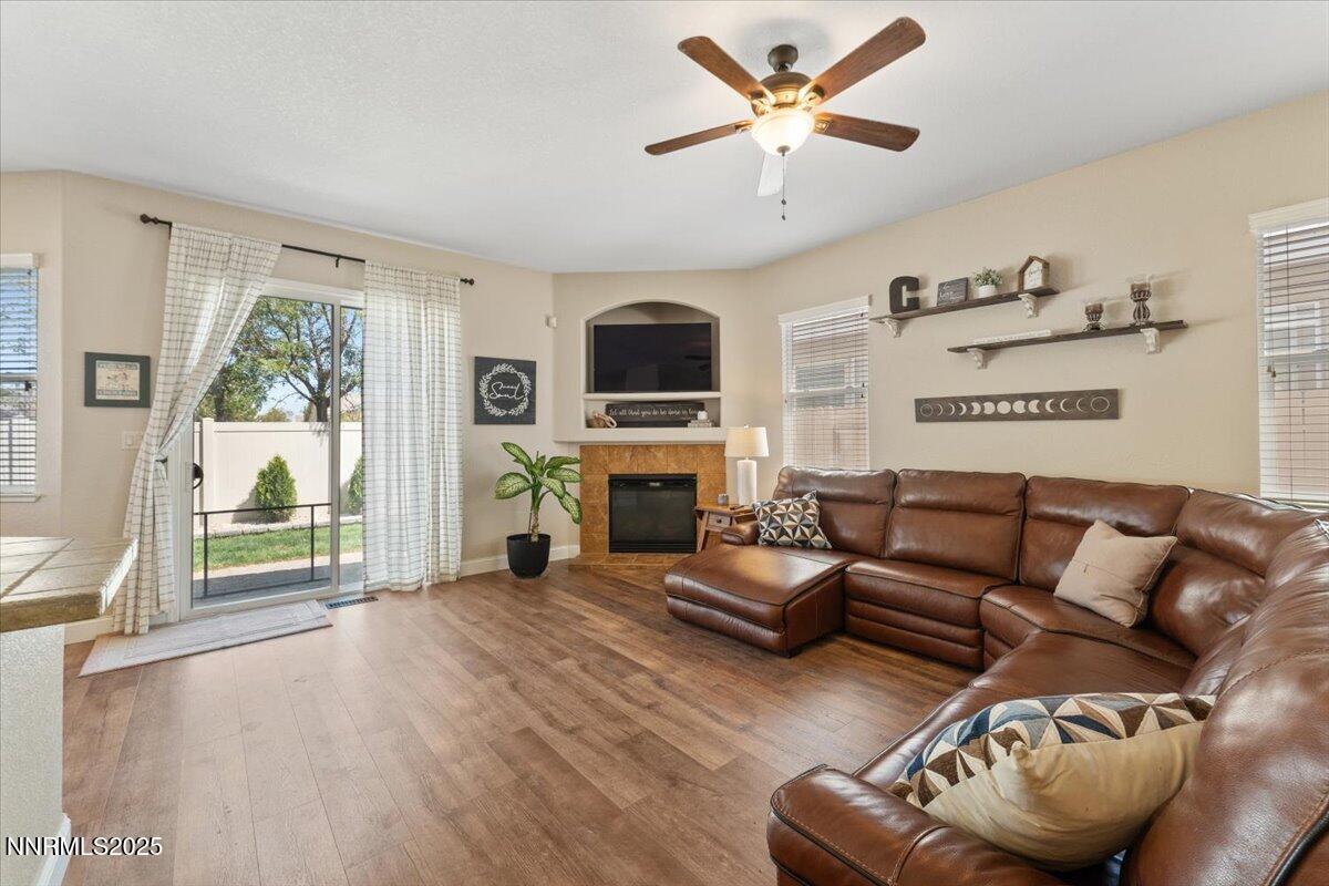 2415 Lincoln Meadows Drive Reno, NV 89521 - Photo 6 of 38 a living room with furniture a fireplace and a large window