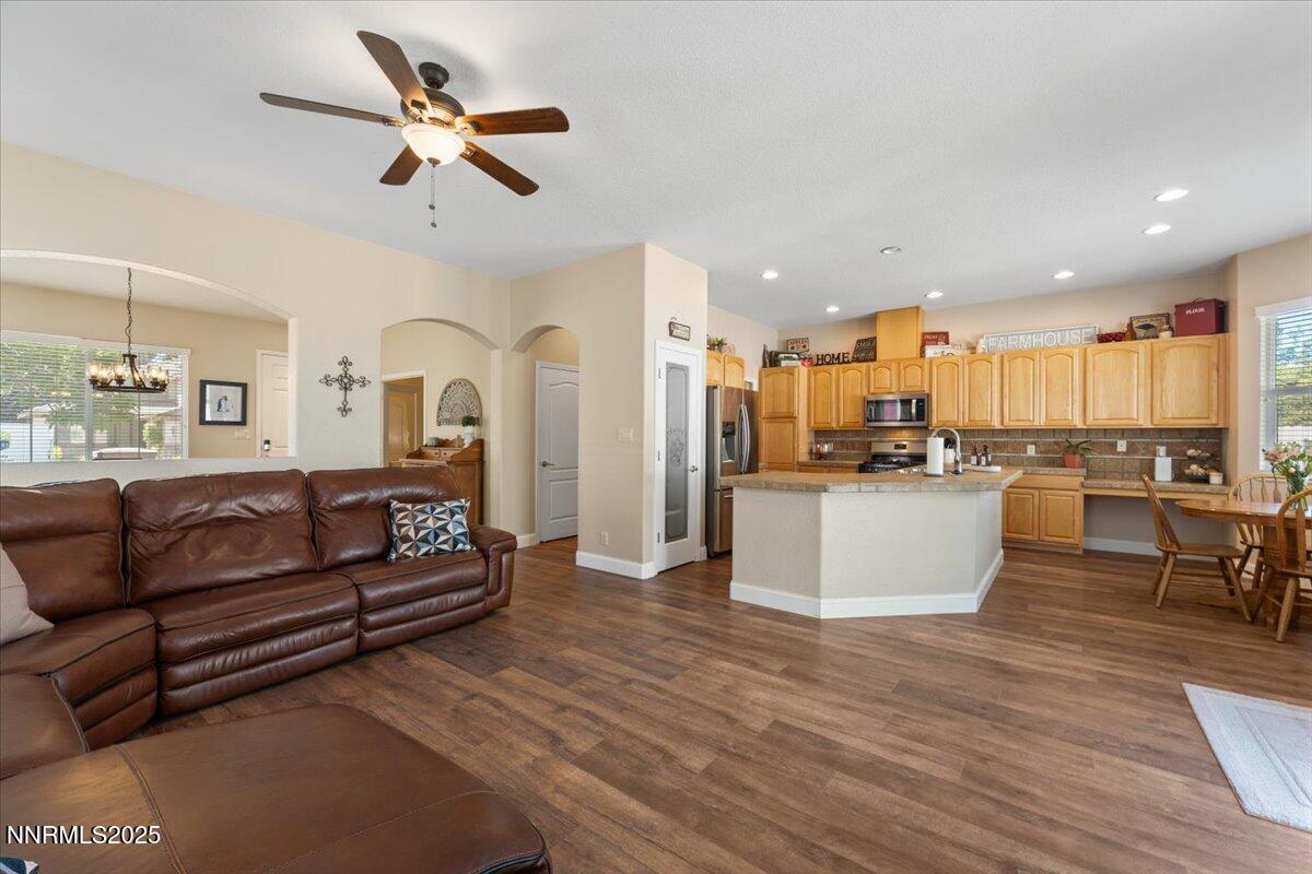 2415 Lincoln Meadows Drive Reno, NV 89521 - Photo 9 of 38 a living room with stainless steel appliances kitchen island granite countertop a couch and a view of kitchen