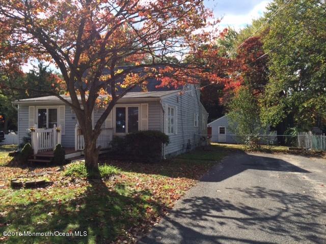 233 Stuart Street Howell, NJ 07731 - Photo 1 of 4 a front view of a house with a yard covered with snow and trees