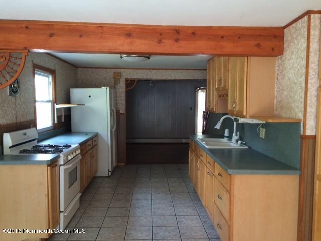 233 Stuart Street Howell, NJ 07731 - Photo 3 of 4 a kitchen with stainless steel appliances granite countertop a sink and a stove