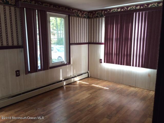 233 Stuart Street Howell, NJ 07731 - Photo 4 of 4 a view of an empty room with wooden floor and a window