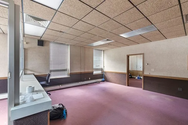 a view of empty room with wooden floor and cabinet