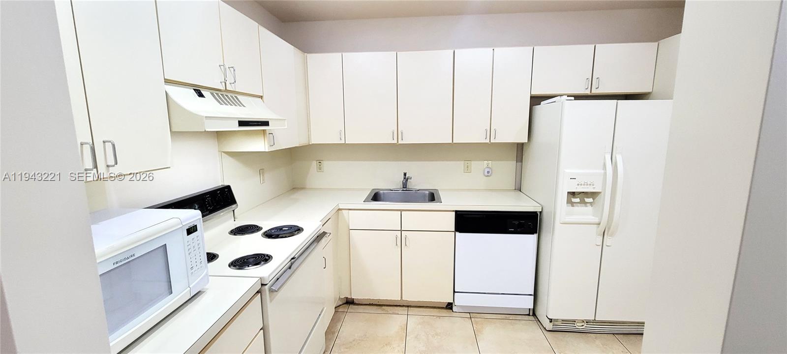 9004 Southwest 137th Street, Unit B Miami, FL 33176 - Photo 4 of 14 a kitchen with stainless steel appliances a refrigerator a sink a stove and white cabinets