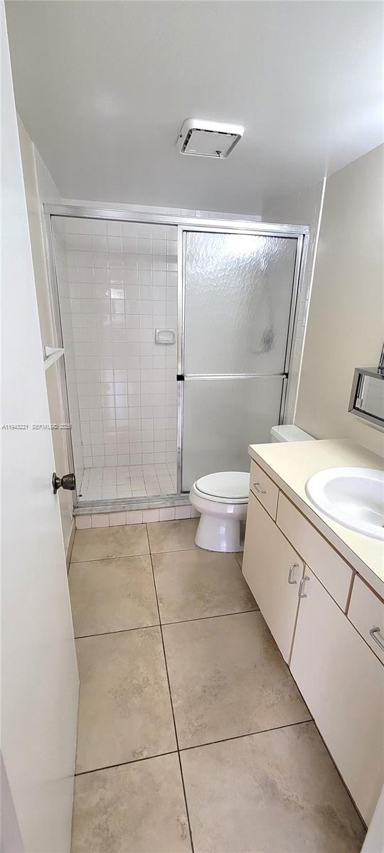 9004 Southwest 137th Street, Unit B Miami, FL 33176 - Photo 6 of 14 a bathroom with a granite countertop sink mirror vanity and toilet