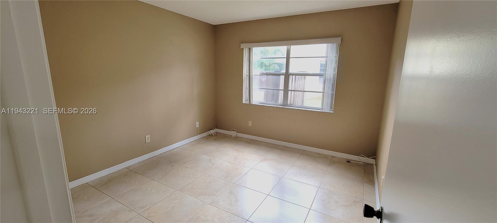 9004 Southwest 137th Street, Unit B Miami, FL 33176 - Photo 8 of 14 an empty room with windows