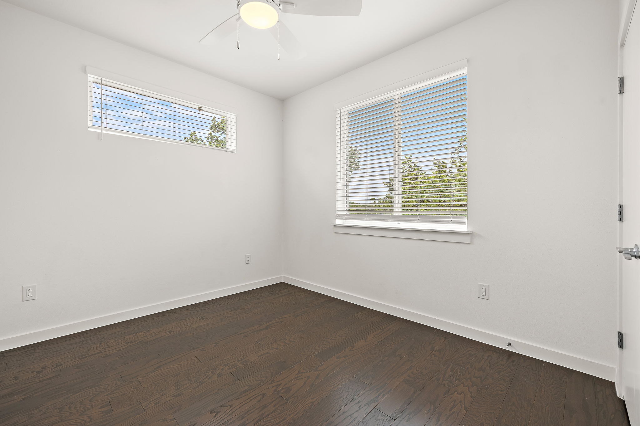 1206 Sarabeth Way Austin, TX 78721 - Photo 18 of 27 Unfurnished room with a ceiling fan, baseboards, and dark wood-style flooring