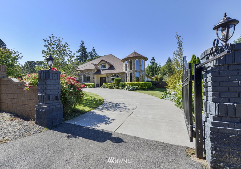 9908 Meadow Road Southwest Lakewood, WA 98499 - Photo 2 of 40 a front view of a house with a yard and garage
