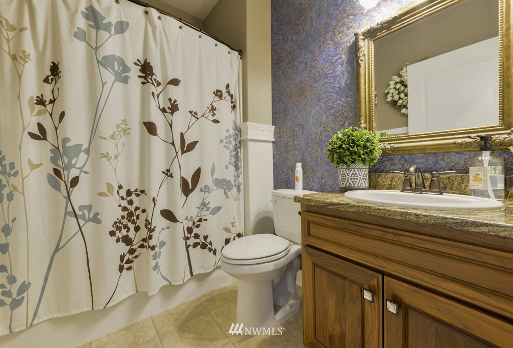 9908 Meadow Road Southwest Lakewood, WA 98499 - Photo 30 of 40 a living room with furniture and a rug
