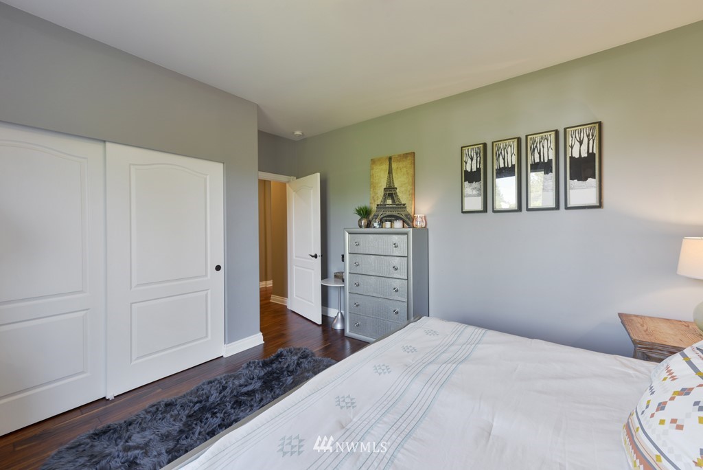 9908 Meadow Road Southwest Lakewood, WA 98499 - Photo 31 of 40 a bedroom with a bed and wooden floor