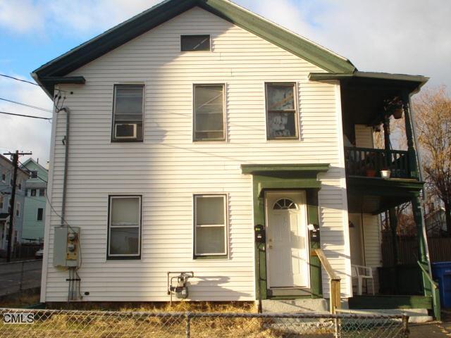 a view of a house with wooden fence
