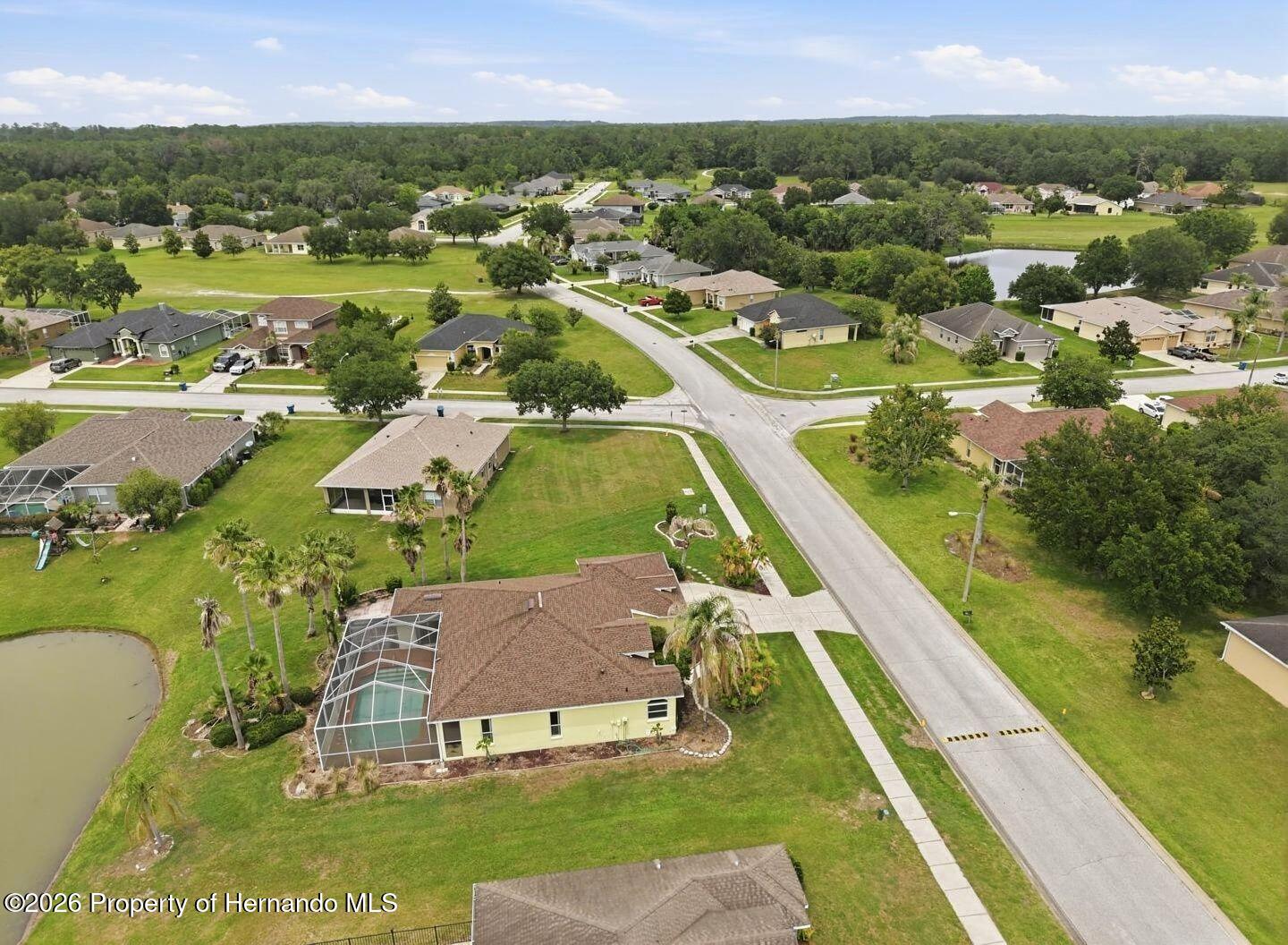 18131 Rivard Boulevard Brooksville, FL 34604 - Photo 56 of 66 an aerial view of residential houses with outdoor space and lake view