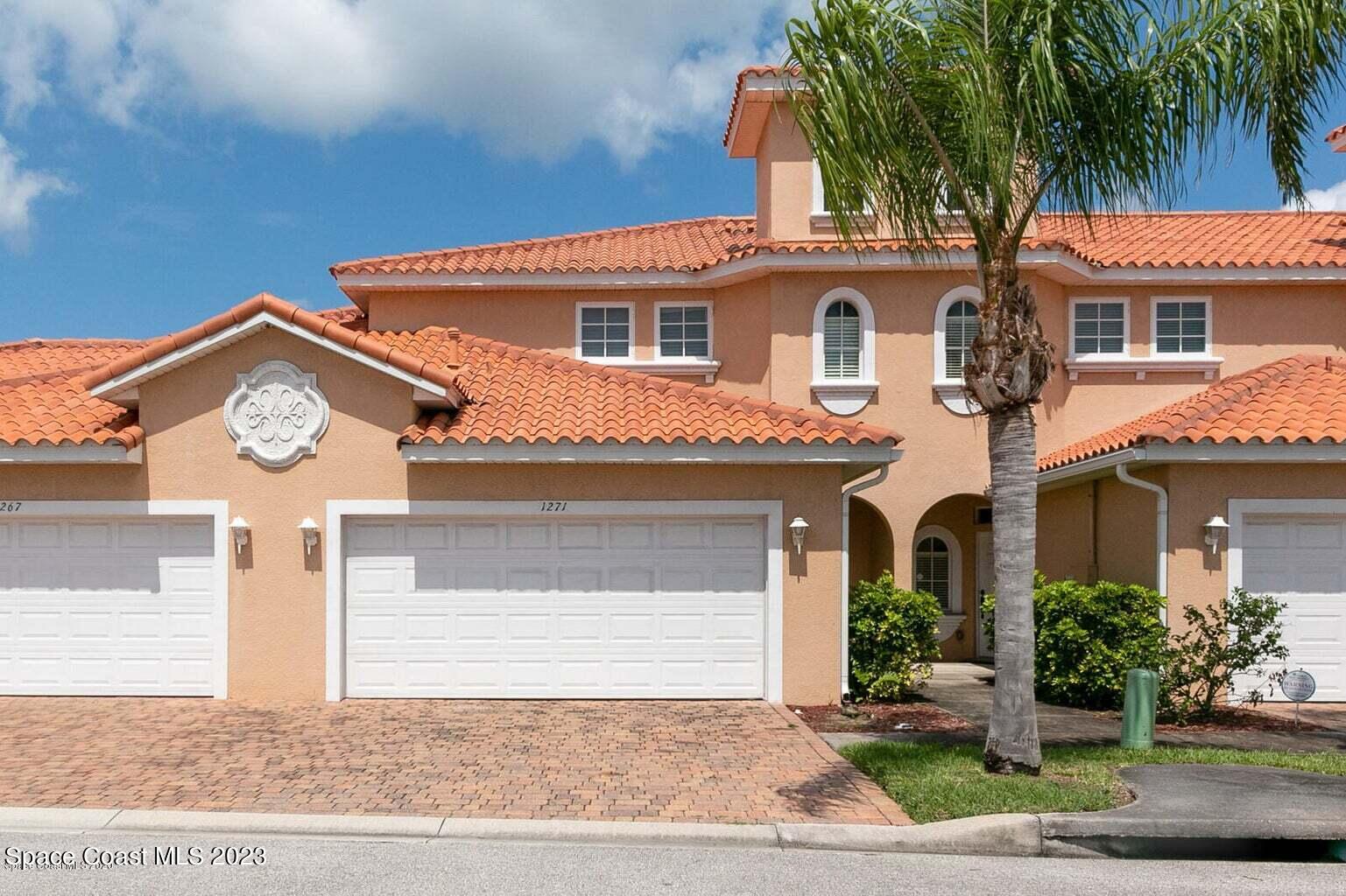 1271 Etruscan Way, Unit 110 Indian Harbour Beach, FL 32937 - Photo 1 of 42 a front view of a house with a yard