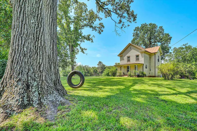 a view of a house with a backyard