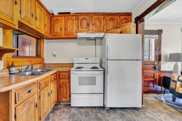 a kitchen with stainless steel appliances granite countertop a stove and cabinets
