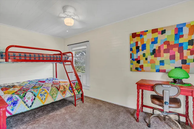 a bedroom with a bed and a painting on the wall