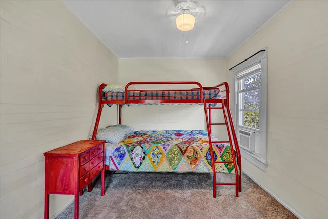 a bedroom with furniture and a window