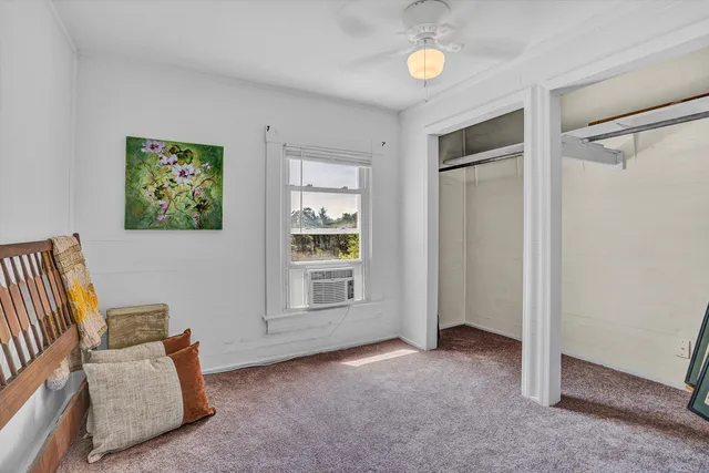 a bed room with a bed and a window