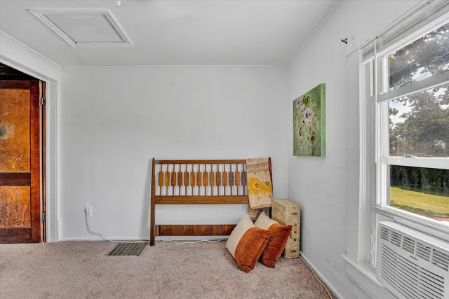 a bedroom with furniture and a window