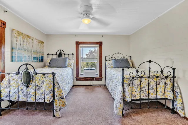 a bedroom with a bed and a refrigerator