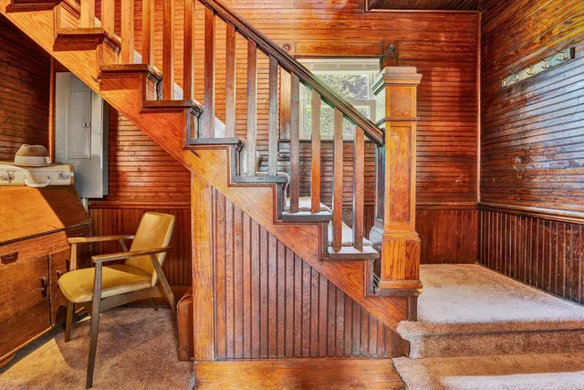 a balcony with chairs and wooden fence