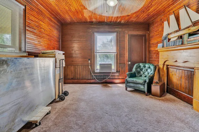 a backyard of a house with barbeque oven table and chairs