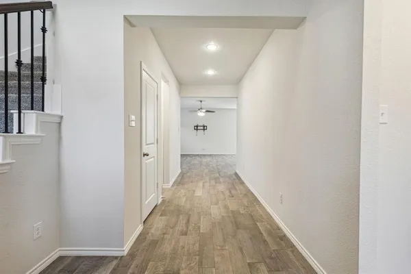a view of a hallway with wooden floor