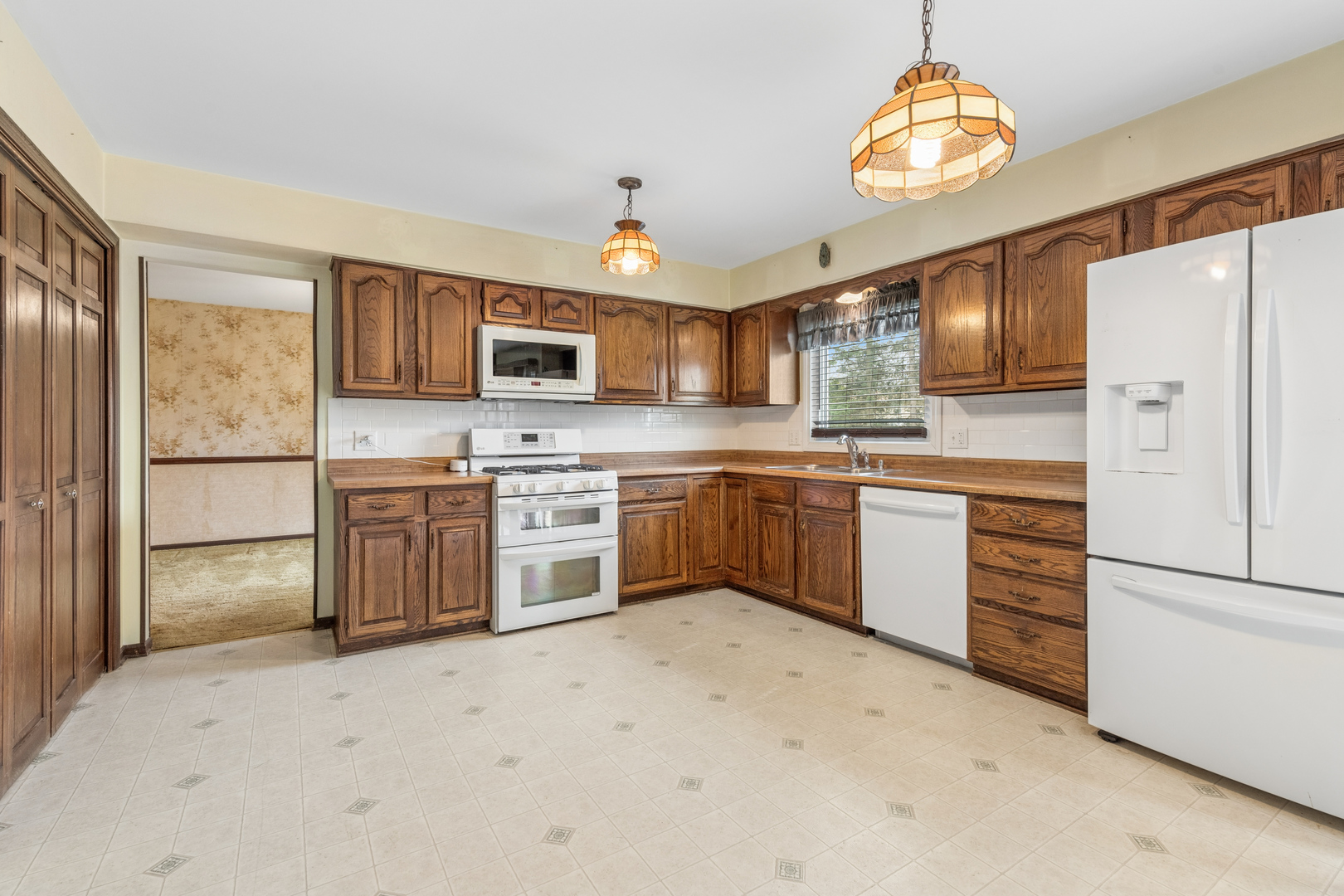 5017 Kenneth Drive Crystal Lake, IL 60014 - Photo 9 of 20 a kitchen with stainless steel appliances granite countertop a stove refrigerator and microwave