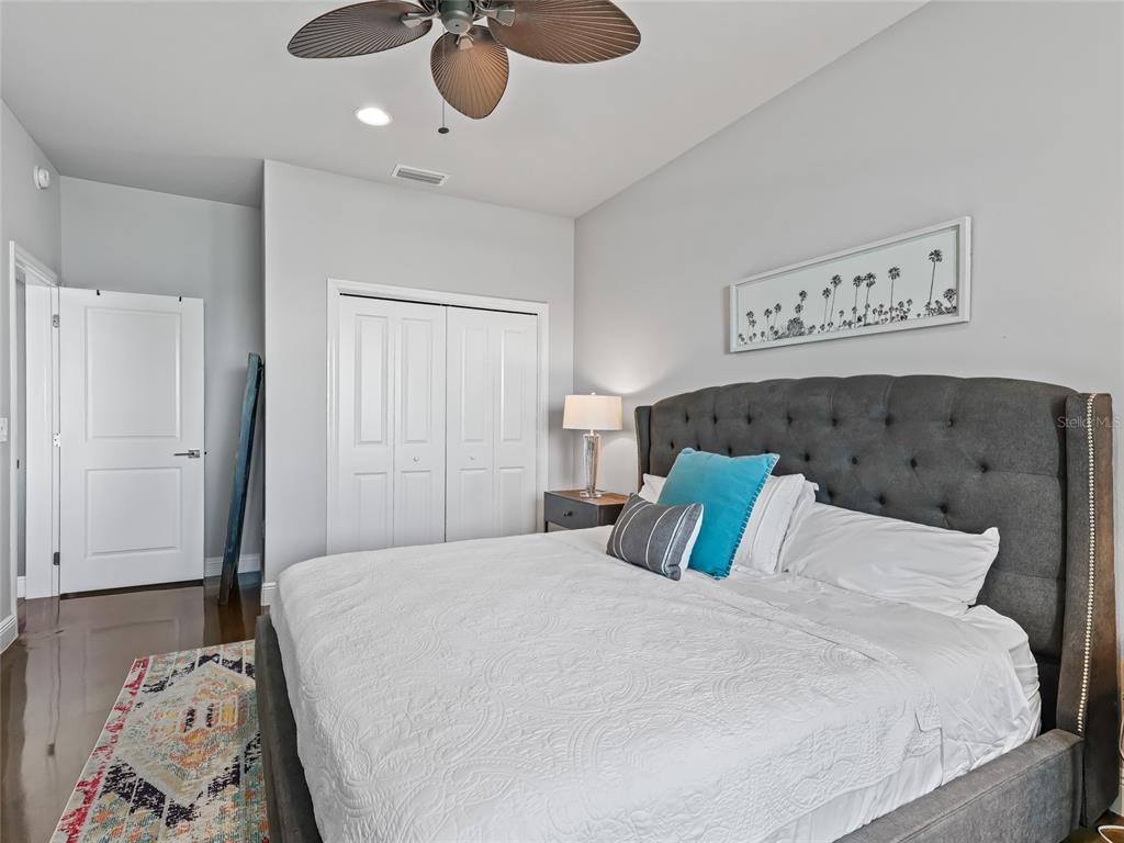 12943 Southeast Sunset Harbor Road Weirsdale, FL 32195 - Photo 59 of 87 a bedroom with a bed and painting on the wall