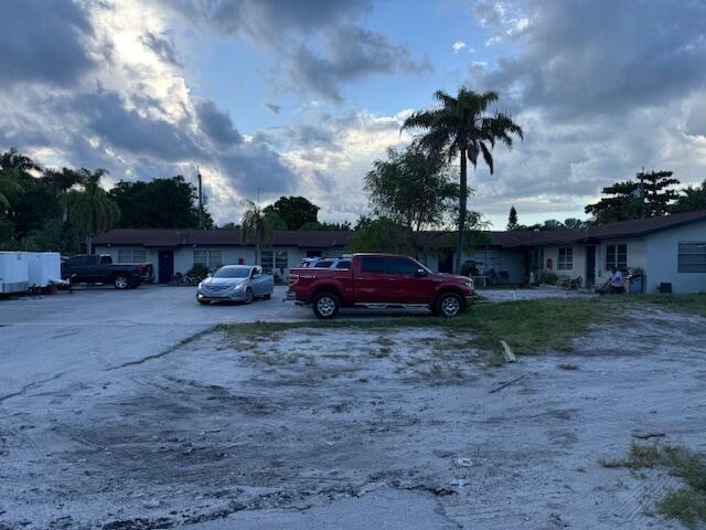 3681 Lakewood Road Palm Springs, FL 33461 - Photo 2 of 2 a view of a house with a cars park