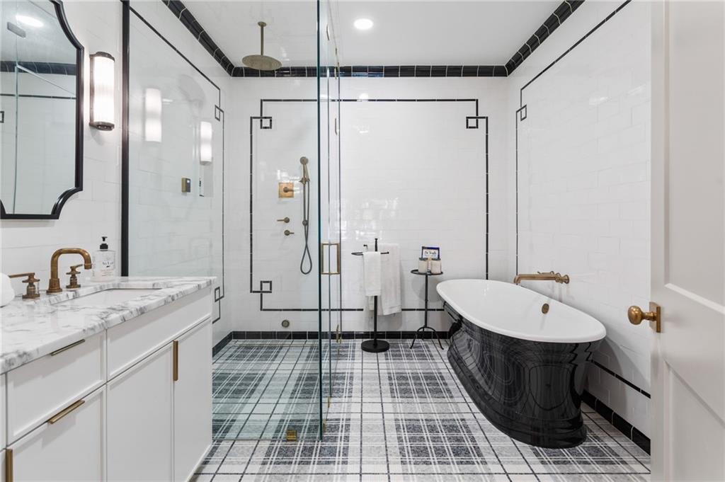 1021 Gilbert Street Southeast Atlanta, GA 30316 - Photo 15 of 24 a bathroom with a double vanity sink a toilet a mirror and shower